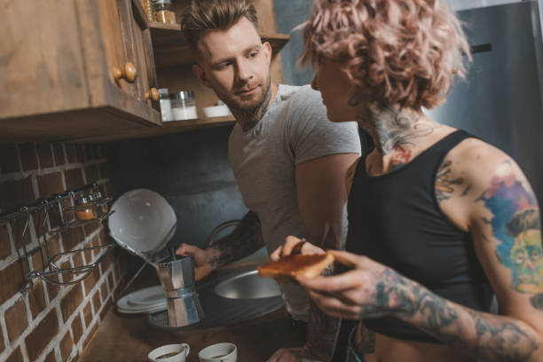 istock tattooed couple cooking breakfast at kitchen 917245952