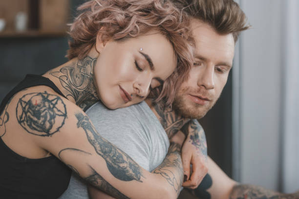 istock young tattooed couple hugging with closed eyes 917250132