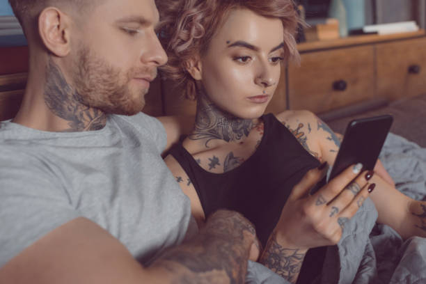 istock attractive caucasian couple using smartphone at home 917250804