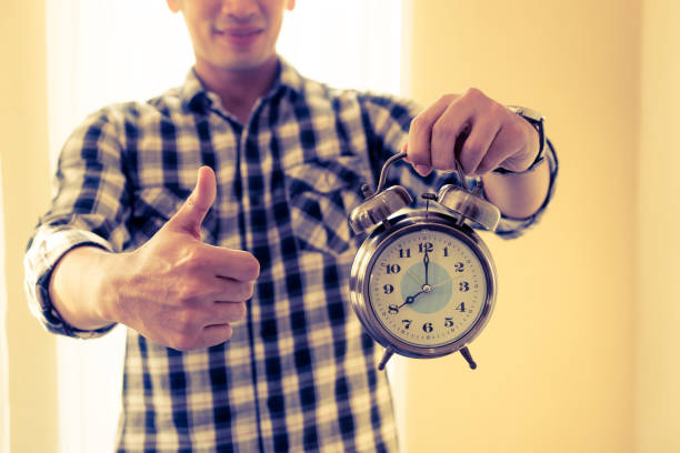 istock Casual business man alarm clock and thumb up 917251168