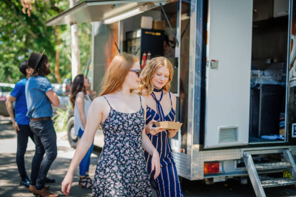 istock Two attractive girls eating fast food 917251202