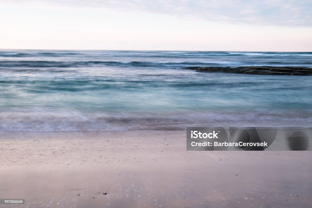 beautiful breaking waves on sandy beach on atlantic ocean in sunset sky, hendaye, basque country, france Atlantic Ocean Stock Photo