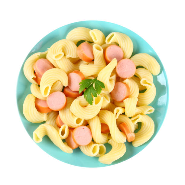 Macaroni with sausages on a blue plate isolated on white background.