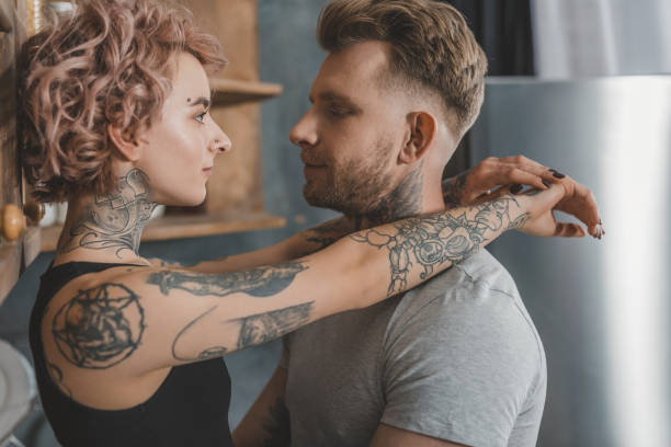 istock tattooed couple hugging and looking at each other 917254878