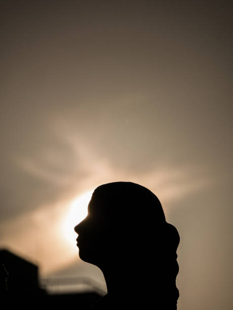 istock Statue of Woman behind The Sun Light 917255842
