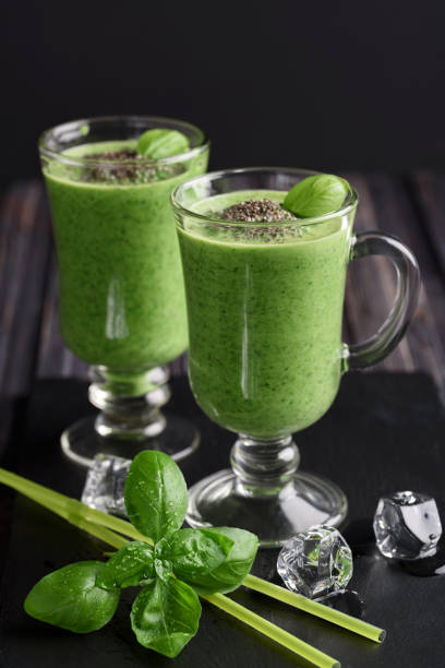 istock Blended green smoothie with ingredients on wooden table 917263106