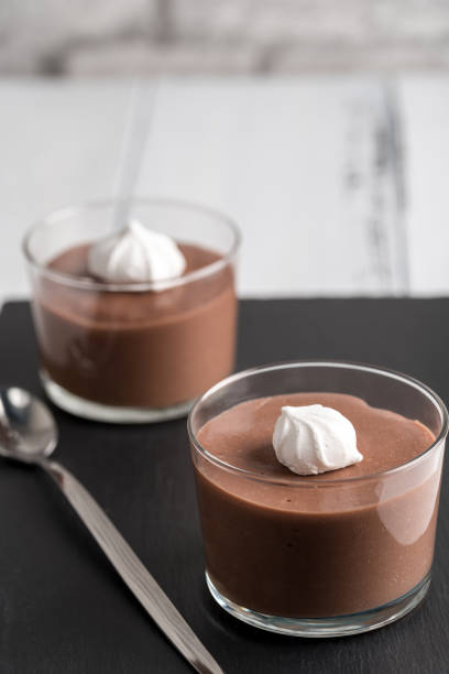istock Chocolate mousse in a glasses on a black stone background. 917263150
