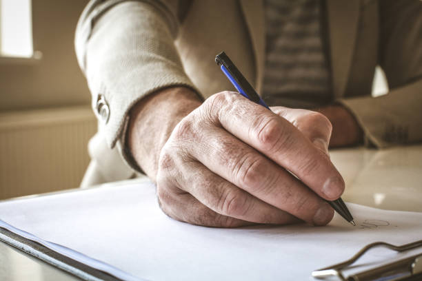 istock Businessman hand sign papers. Close up.. 917263404