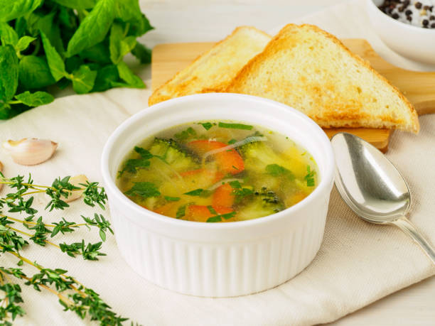 istock Delicious, thick Soup with mixed vegetables - cauliflower, broccoli, carrots, potatoes, garlic, tomatoes.  Healthy diet food. Close-up, side view 917266172
