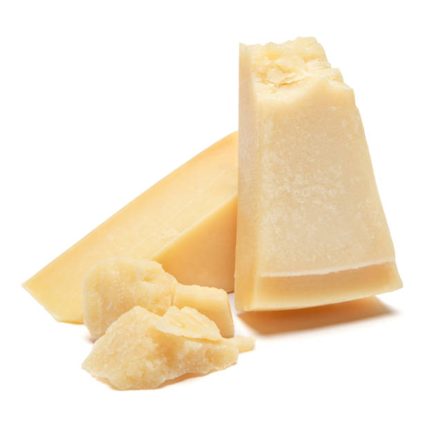 piece of parmesan cheese on white background - parmesan cheese imagens e fotografias de stock
