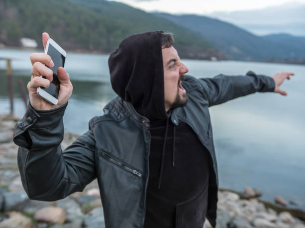 istock Angry man throwing his smart phone into the lake water 917272368