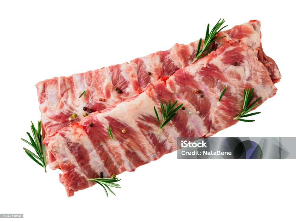 Isolated image of raw pork ribs with seasoning  rosemary, pepper on white background, top view Pork Stock Photo