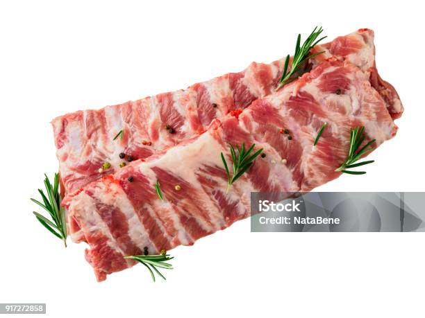 Isolated Image Of Raw Pork Ribs With Seasoning Rosemary Pepper On White Background Top View Stock Photo - Download Image Now