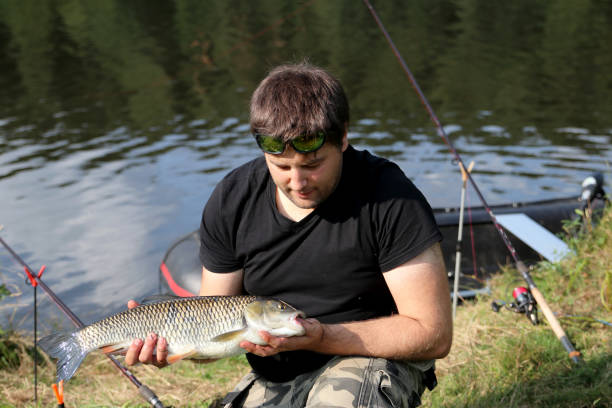 istock Young man with tent while fishing 917272930