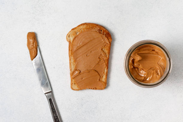 Toast With Peanut Butter Stock Photo - Download Image Now - Peanut Butter,  Kitchen Knife, Spreading - iStock