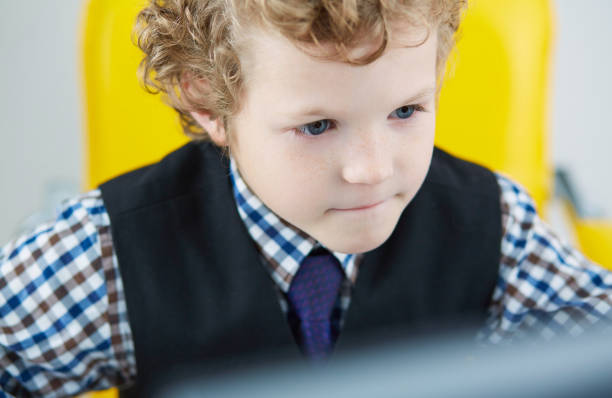 istock Close-up portrait of a boy looking at a computer screen 917276442