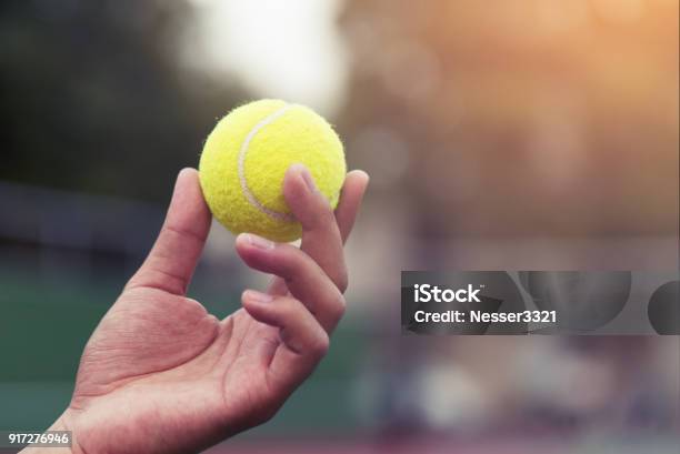 Tennis Player Holding The Ball And Getting Ready To Serve Stock Photo - Download Image Now