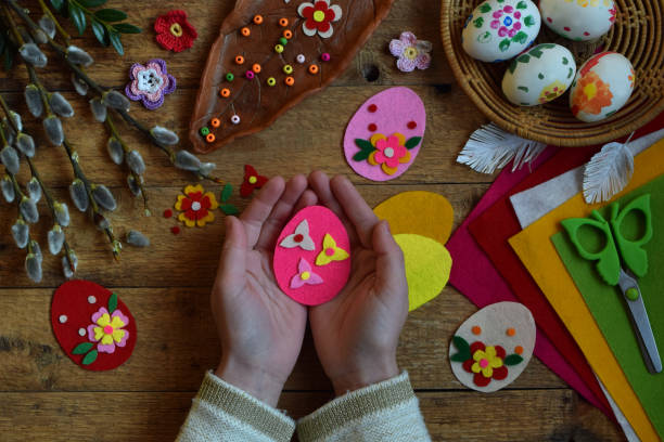 istock Making of handmade easter eggs from felt with your own hands. Children's DIY concept. Making Easter decoration or greeting card. Step 3. The finished toy egg. 917276960