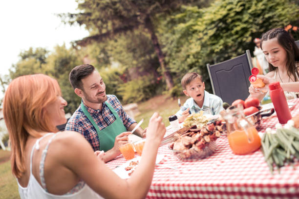 istock Happy young family having lunch barbecue 917278846