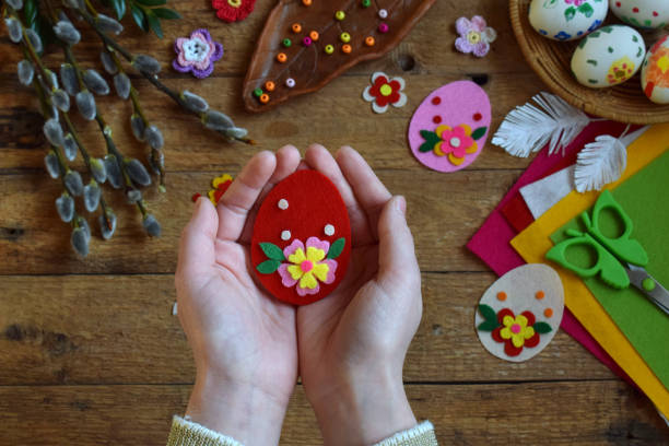istock Making of handmade easter eggs from felt with your own hands. Children's DIY concept. Making Easter decoration or greeting card. Step 3. The finished toy egg. 917279852
