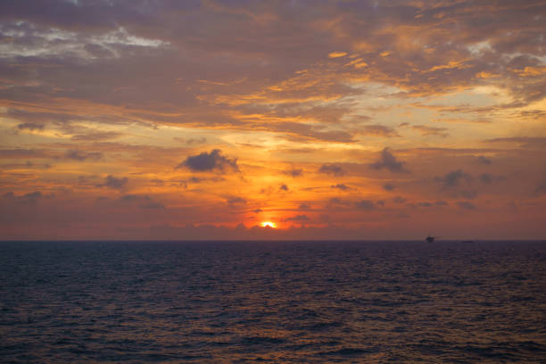 istock Beautiful sunset with sky over calm sea and offshore platform. 917299234