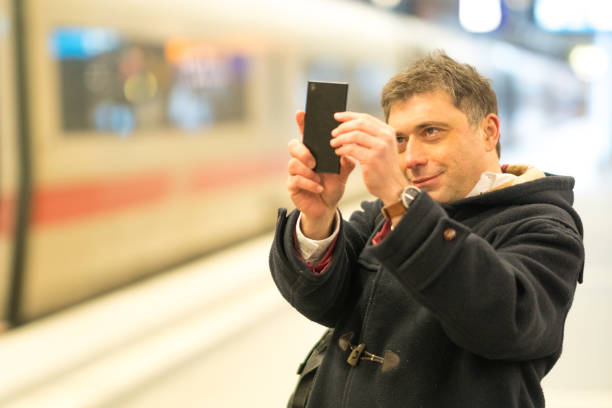 istock Taking photos at train station 917299554