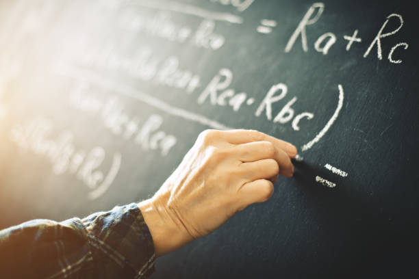 istock The teacher writes on a board with chalk a formula for electric current 917303112