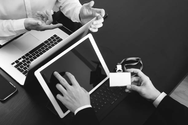 istock co working team meeting concept,businessman using smart phone and digital tablet and laptop computer and name tag in modern office 917303440