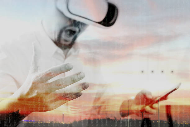 istock businessman wearing virtual reality goggles in modern office with mobile phone using with VR headset 917306196