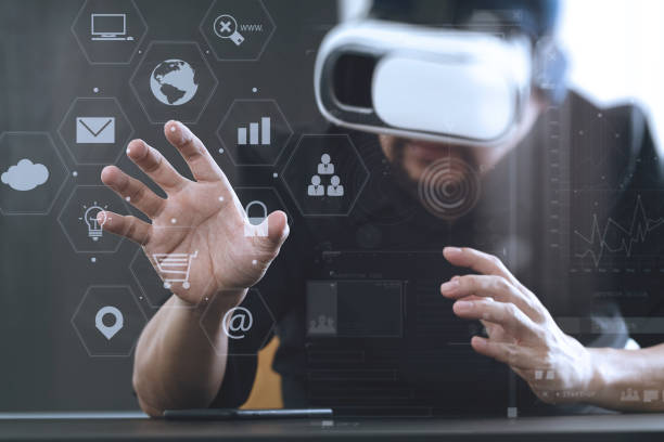 istock businessman wearing virtual reality goggles in modern office with mobile phone using with VR headset with screen icon diagram 917306382