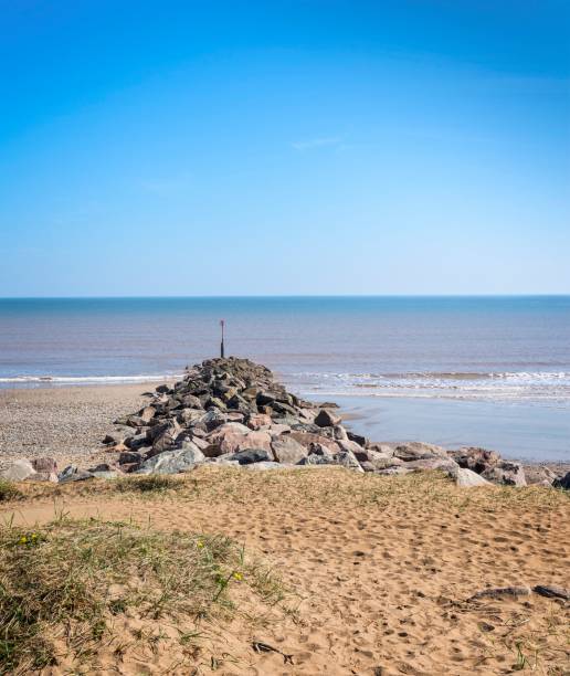 istock Groyne or breakwater points out to sea. 917311152