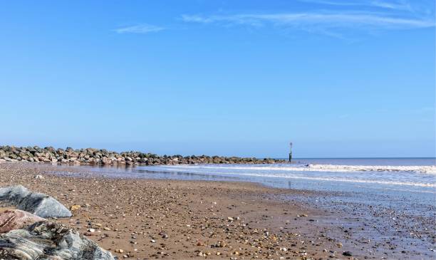 istock Groyne or breakwater points out to sea. 917311154