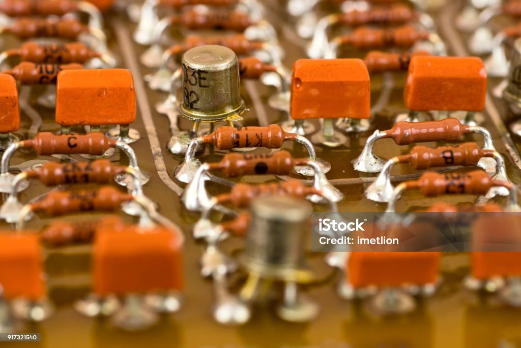 Electronic components on circuit board Vintage electronic components on printed circuit board Backgrounds Stock Photo