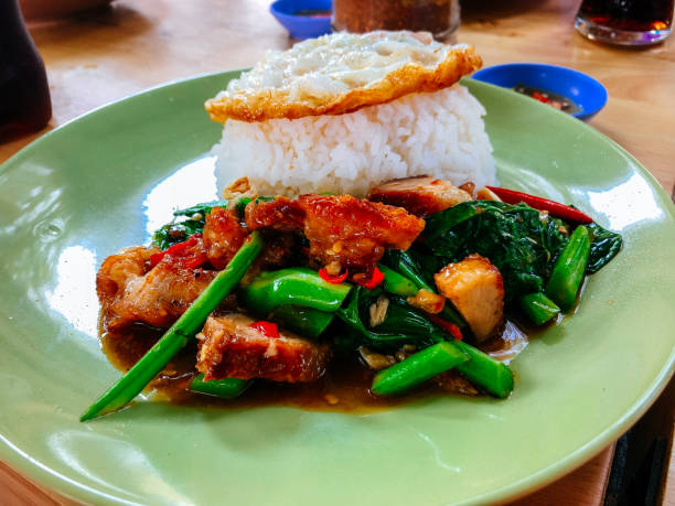 istock Stir fried pork with Thai Jasmine rice in  green plate 917323084