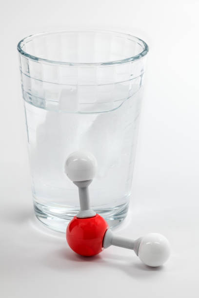 istock Chemistry molecule for water and a glass willed with the element 917323626