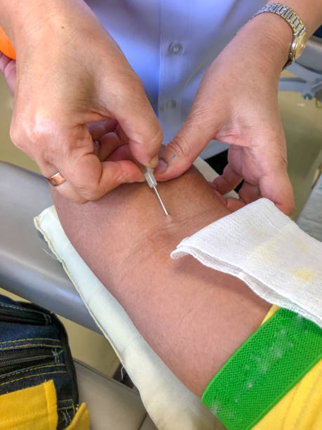 istock nurse disinfecting male arm before blood test. 917328470
