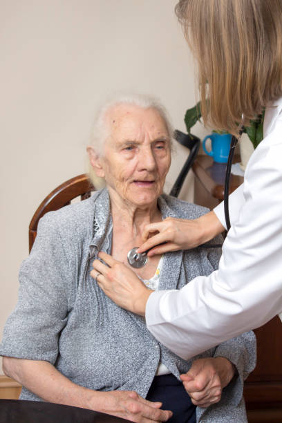 istock Doctor in white smock testing a very old woman with a stethoscope. 917336120