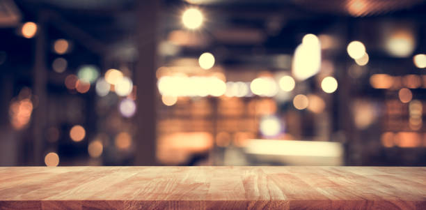 istock Wood table top (Bar) with blur light bokeh in dark night cafe,restaurant background 917339790