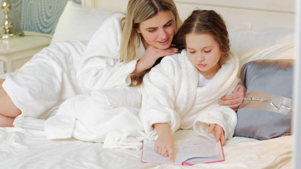 istock child bedtime story mom daughter read together 917347912
