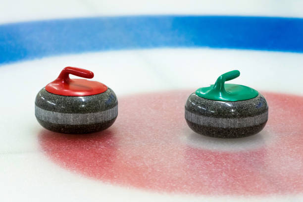 istock curling stones in the target on the ice 917353068