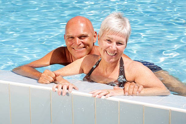 istock happy mature couple in swimming pool 91735538