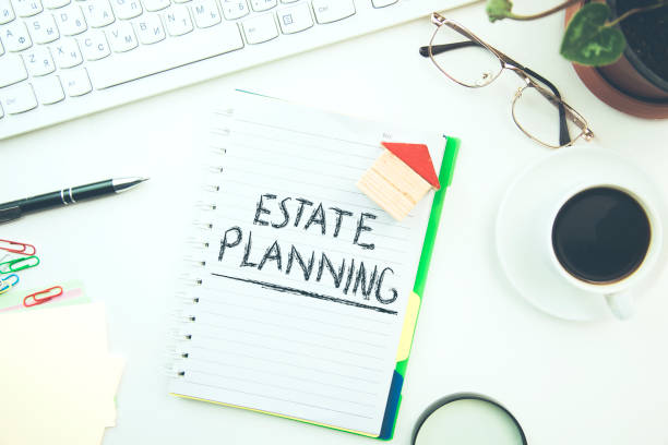 istock Estate Planning text on notepad and house model 917356650