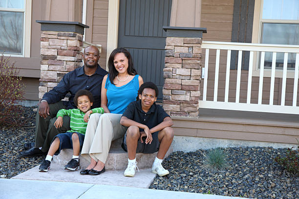 istock Family on front steps of home 91736161