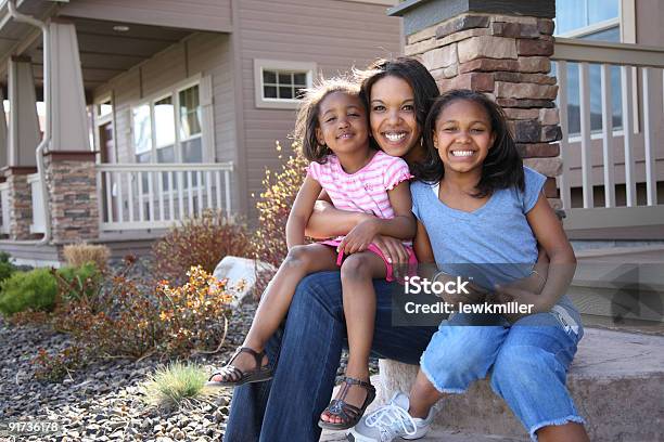 A Mother And Two Little Girls Smiling On A Front Porch Stock Photo - Download Image Now