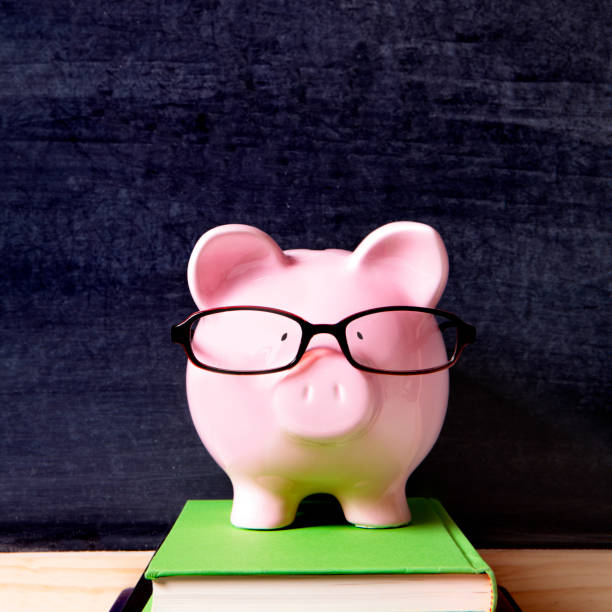 istock Piggy bank with glasses and blackboard 917365950