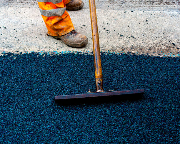 Worker on Asphalting paver machine during Road street repairing works Worker on Asphalting paver machine during Road street repairing works tar stock pictures, royalty-free photos & images