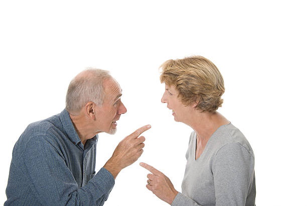 Senior couple arguing animatedly. stock photo