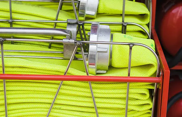 A fire-hose folded in place in a fire truck ready to save lives.
