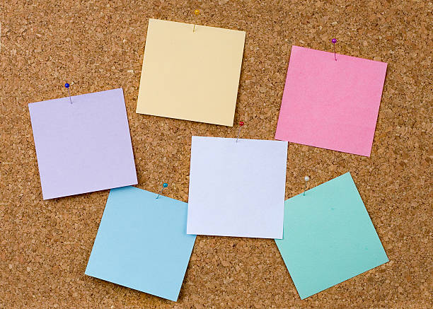 corkboard with pinned color notes stock photo