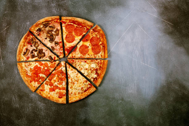 istock Slices of pizza with different fillings on a dark textured background 917379546
